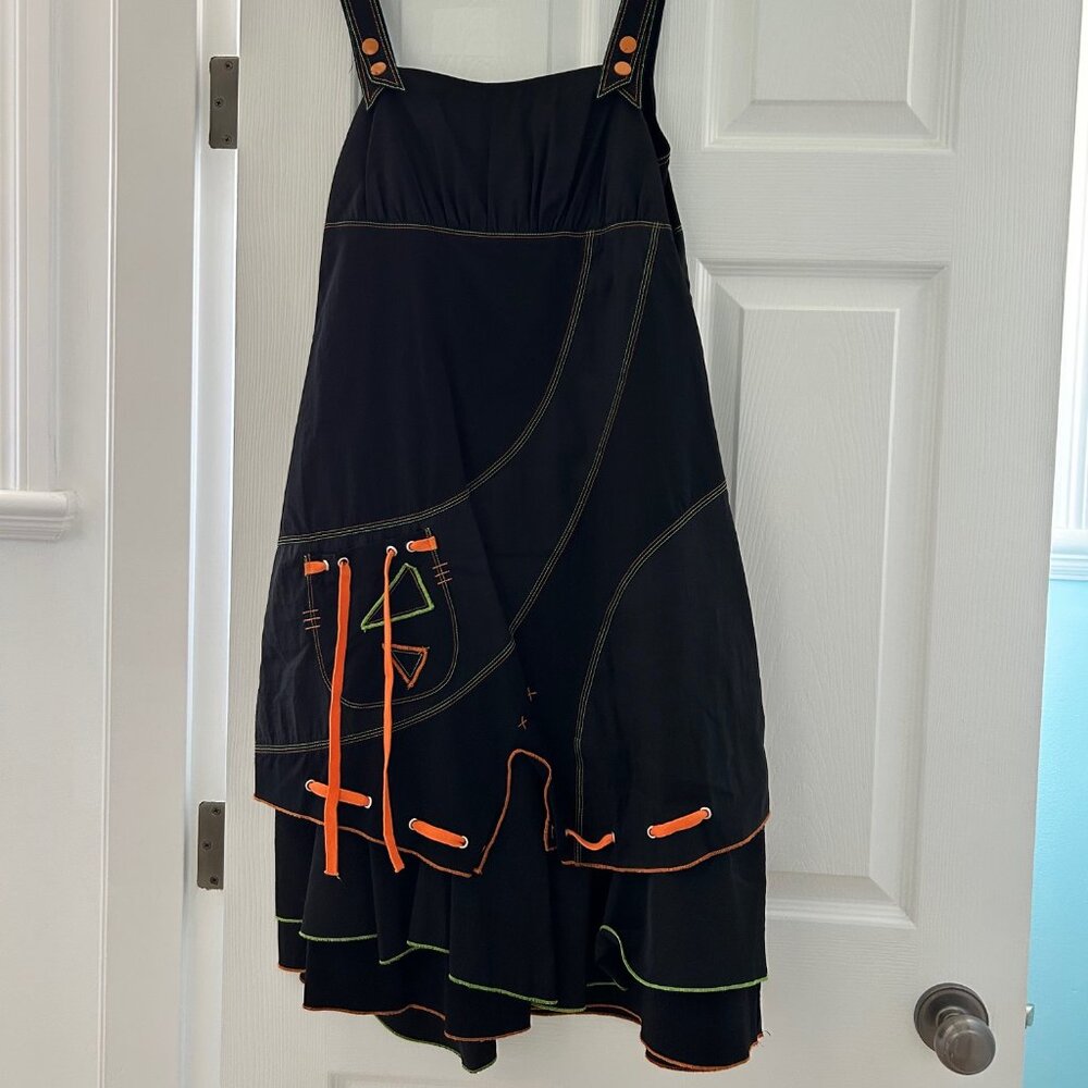 Unique black pinafore dress with orange and green stitching, ribbons & buttons
